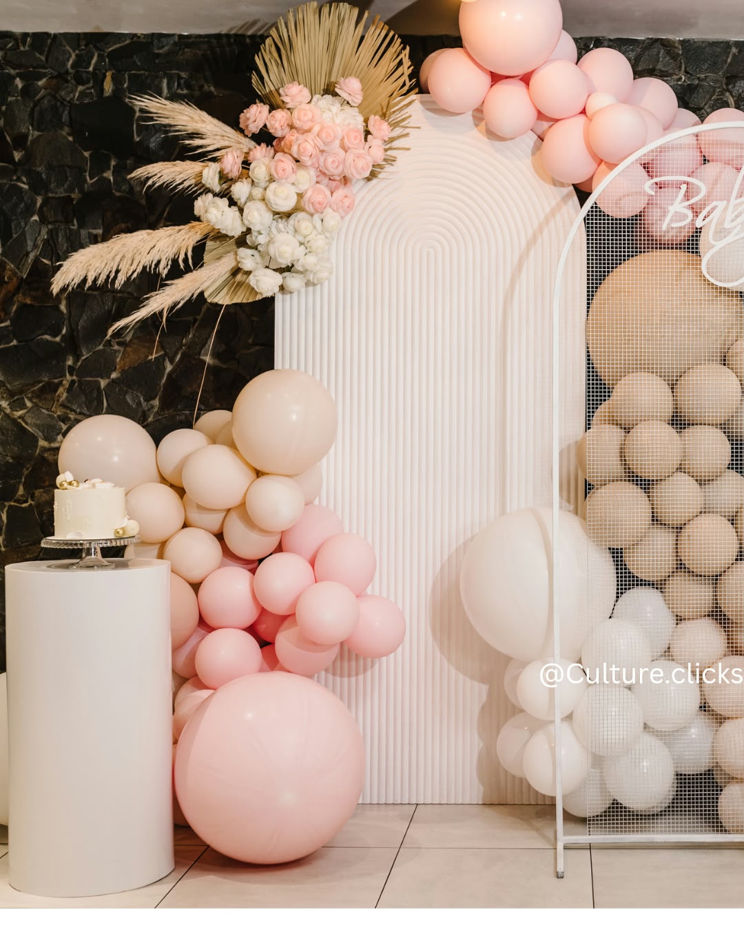 Blush pink balloon garland with pampas grass and florals for a baby shower